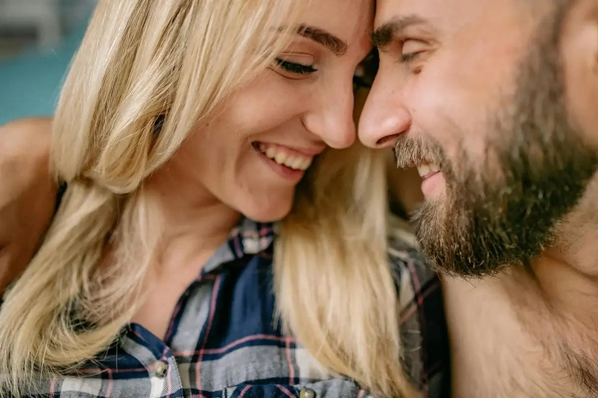 Smiling couple with noses touching in an intimate, close-up moment