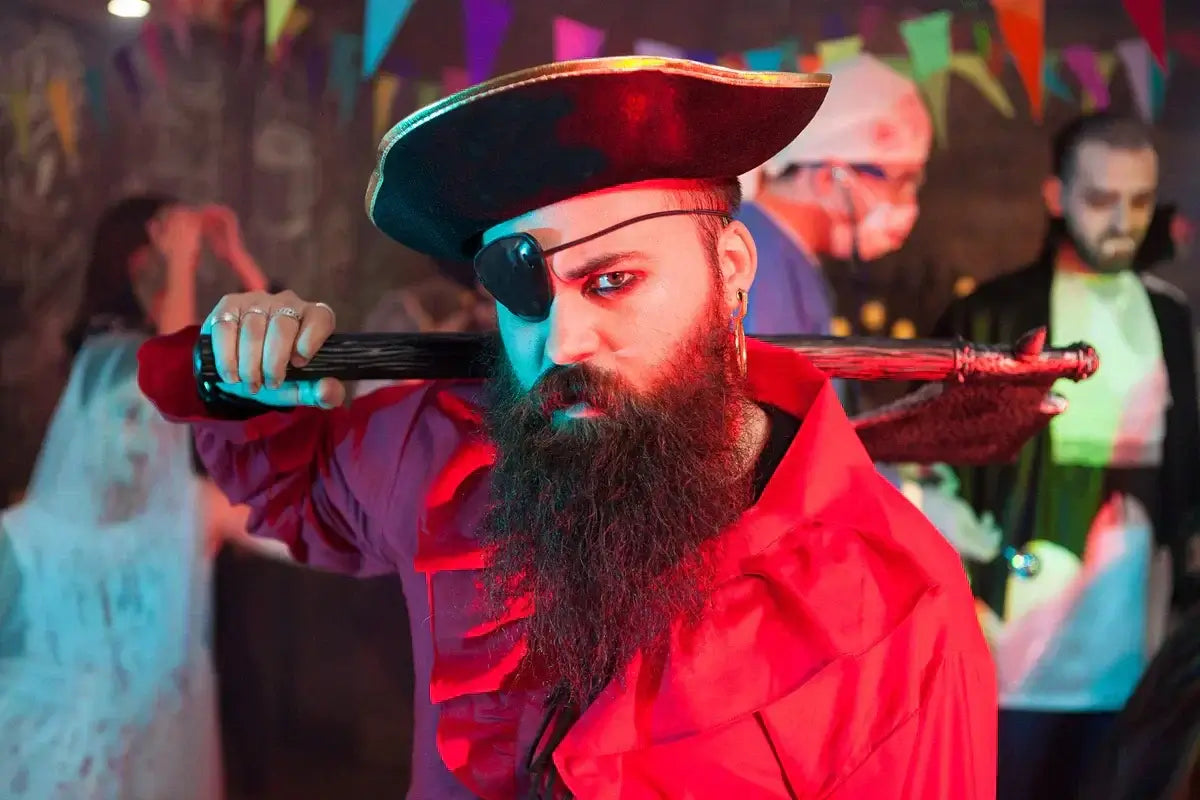 Bearded man in pirate costume with eye patch and tricorn hat at a Halloween party