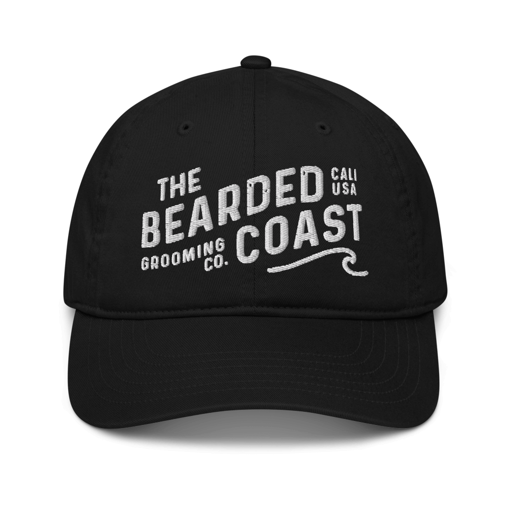 Black baseball cap with “The Bearded Coast Grooming Co.” embroidered in white on the front.