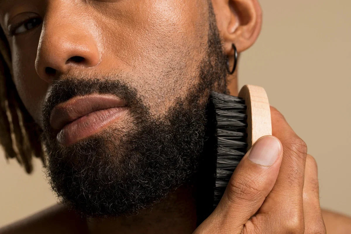 person brushing beard with vegan bristle brush for healthy skin