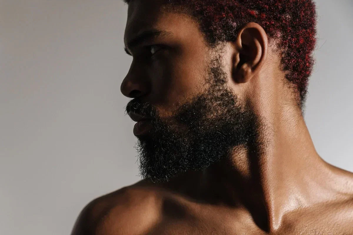 person with healthy well-groomed coily beard