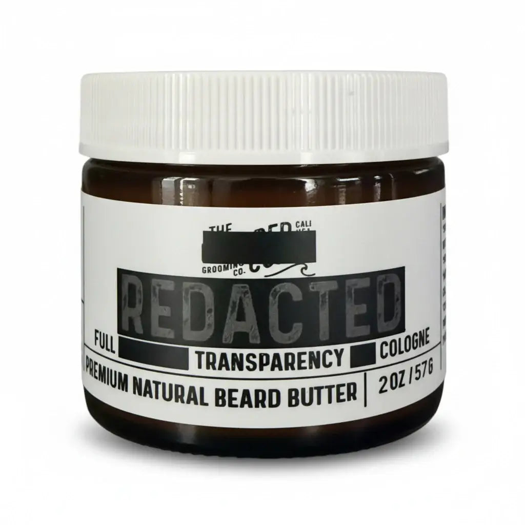 "Redacted" scent beard butter jar with white label, amber glass, and bold black text reading “Full Transparency Cologne.”