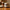 Beard butter jar labeled True O.G. on sunlit wooden table beside a shaving brush and open book