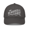 Charcoal baseball cap with “The Bearded Coast Grooming Co.” embroidered in white on the front.