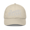 Beige baseball cap with “The Bearded Coast Grooming Co.” embroidered in white on the front.
